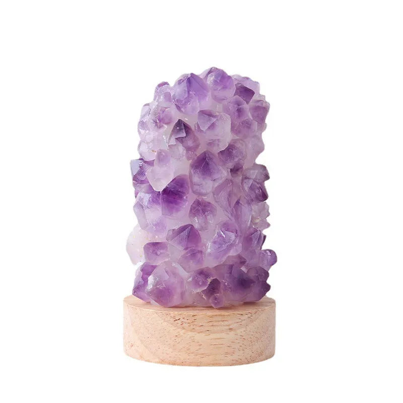 Natural amethyst vug tooth flower mini night light USB plug-in crystal lamp with warm light option on a wooden surface