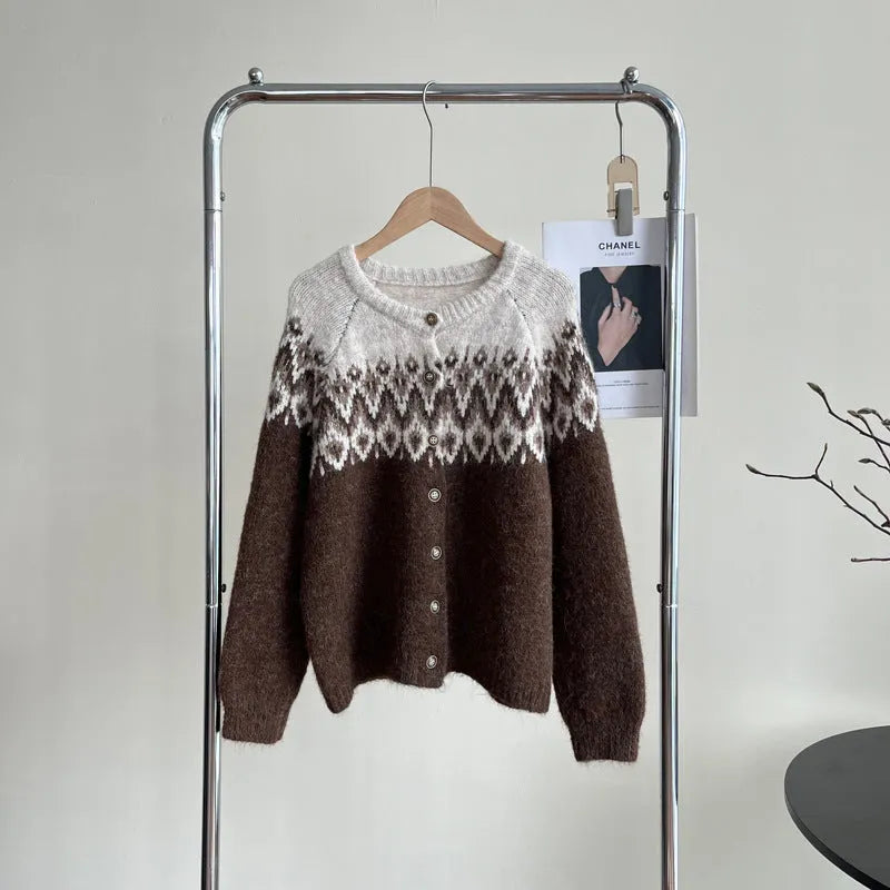 Women's beige jacquard knit sweater coat with loose fit and long sleeves on a hanger.