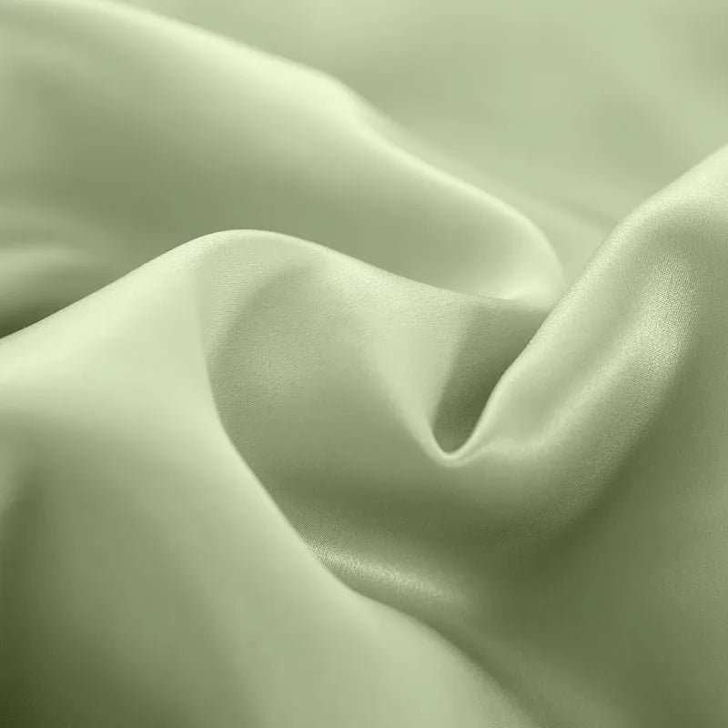 Solid colour silk duvet cover in Lotus Pink showing plain weave texture on a bed.