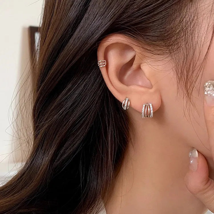 A pair of geometric-shaped 925 silver tone earrings with hypoallergenic needle studs, shown in large size.