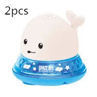 White and blue electric whale bath toy spraying water with lights on a base.