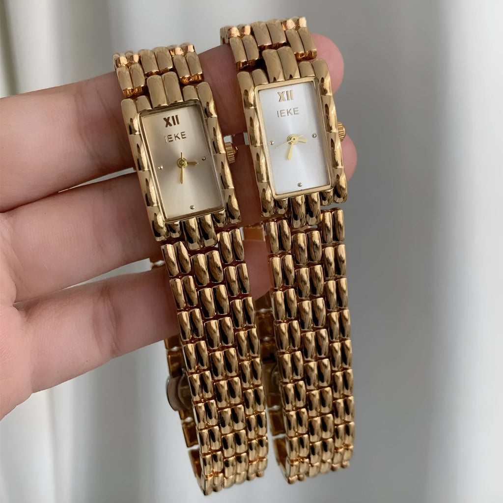 Women's stainless steel bracelet watch with 15mm dial, showing gold strap and white face option.