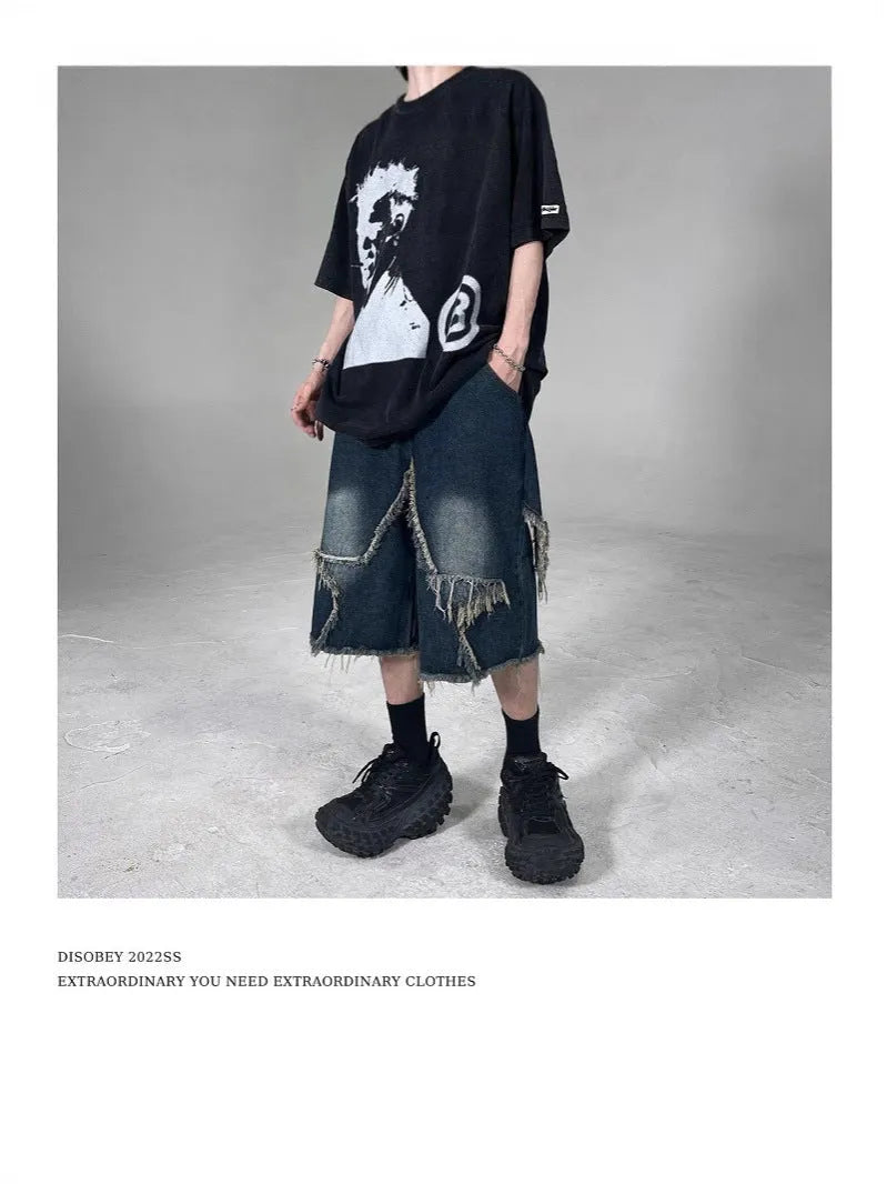 Blue denim shorts with five-pointed star embroidery and frayed edges, loose fit silhouette