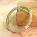 Green jade waxy bracelet with geometric beads and adjustable sizing from 53-64mm
