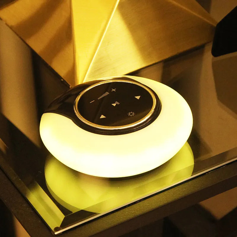 Blue folding Bluetooth desk lamp speaker with touch controls and LED light.