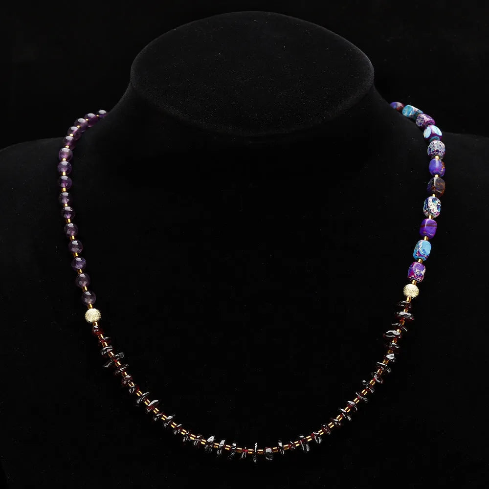 Amethyst round beads stone bracelet with purple garnet and geometric texture on plain background
