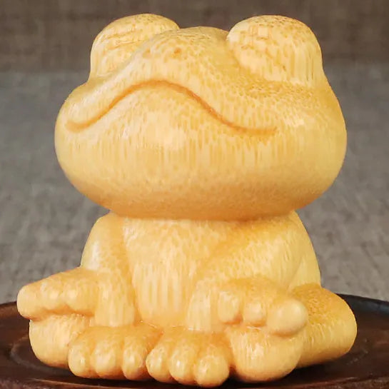 Solid bamboo smiling frog cartoon ornament measuring 5cm tall.