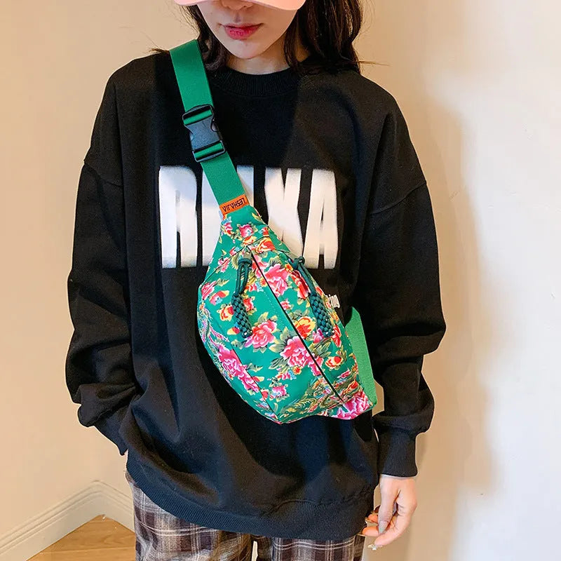 Women's nylon waist bag with big floral pattern, contrast stitching, and three-dimensional outer pocket in black