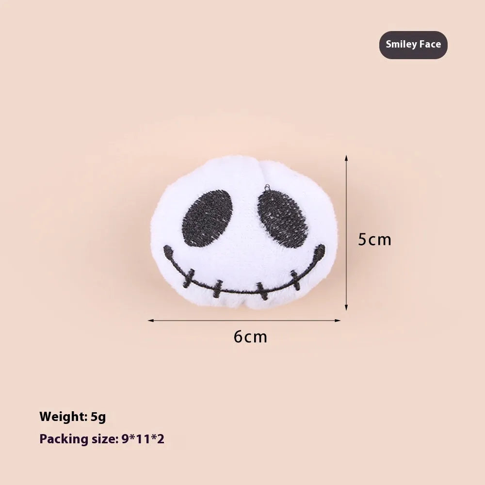 Small plush cat teaser wand with replaceable candy and skull head designs for interactive feline play
