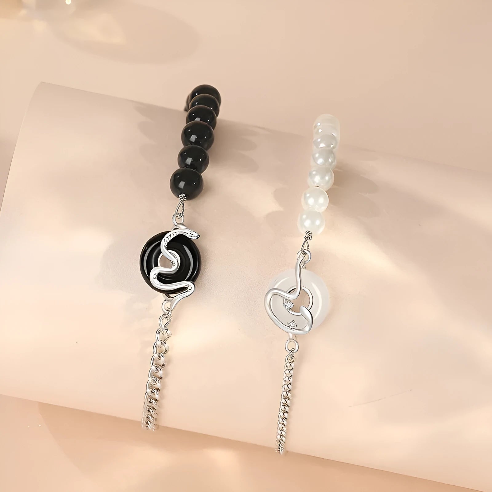 A New Chinese style 925 sterling silver couple bracelet with an obsidian pearl and snake zodiac motif on a secure buckle.