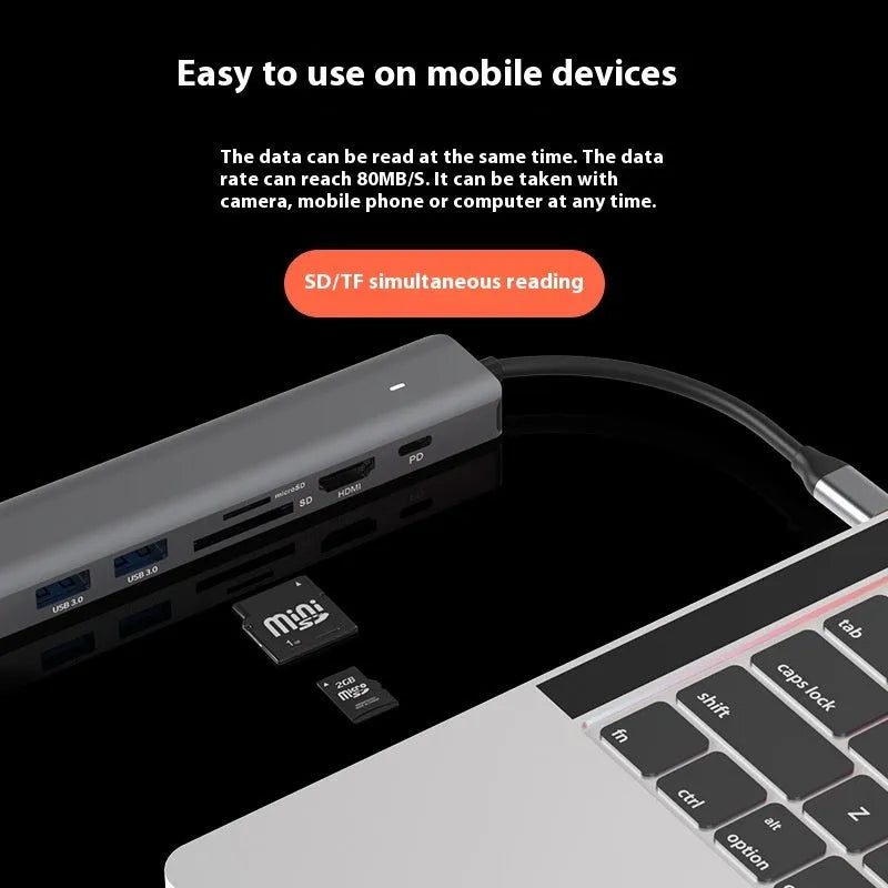 Silver aluminium USB C 7-in-1 hub with HDMI, USB 3.0 ports, and SD card slots.