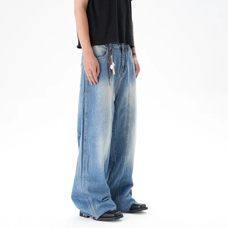 Light blue wide leg machete jeans with vintage washed denim finish, zip-fly closure, cut wash effect