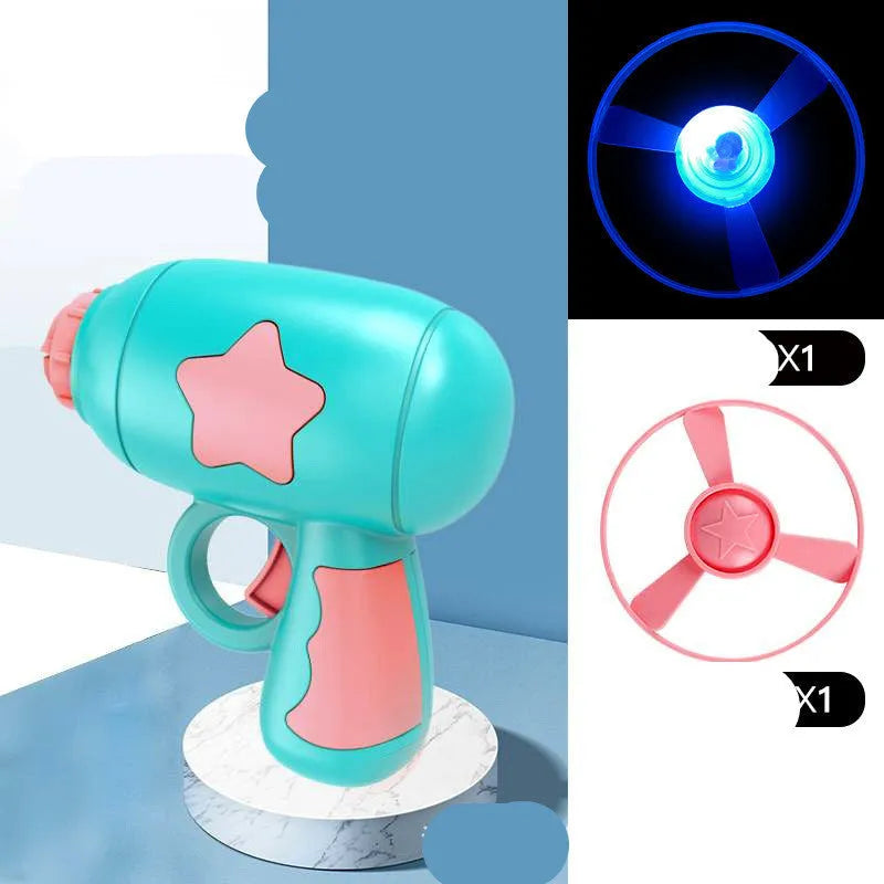 Flying saucer launcher toy with three blue flashing LED discs and target board on blister card