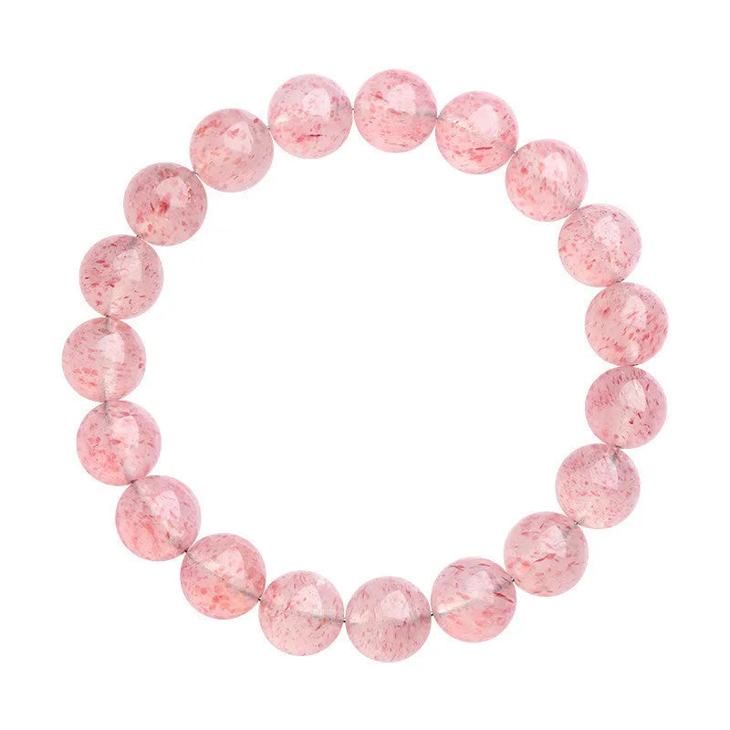 Strawberry quartz crystal bracelet with white geometric beads on a stretch band.