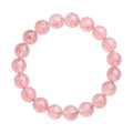 Strawberry quartz crystal bracelet with white geometric beads on a stretch band.