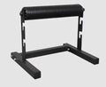 Black steel leg press trainer for split squats and balance exercises in a home gym setting