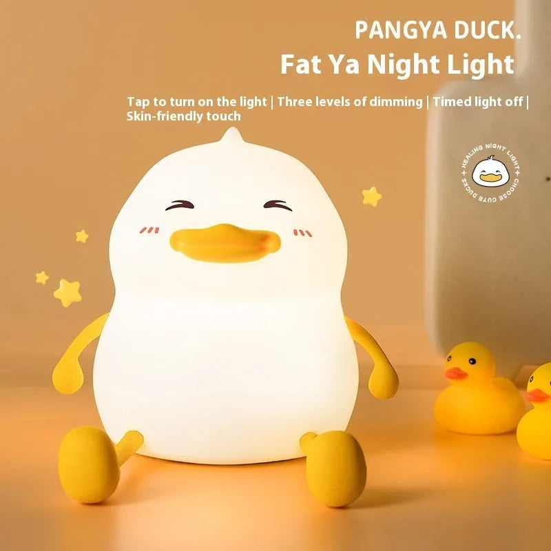 Chubby silicone night lamp on a desk showing phone holder and soft LED glow.
