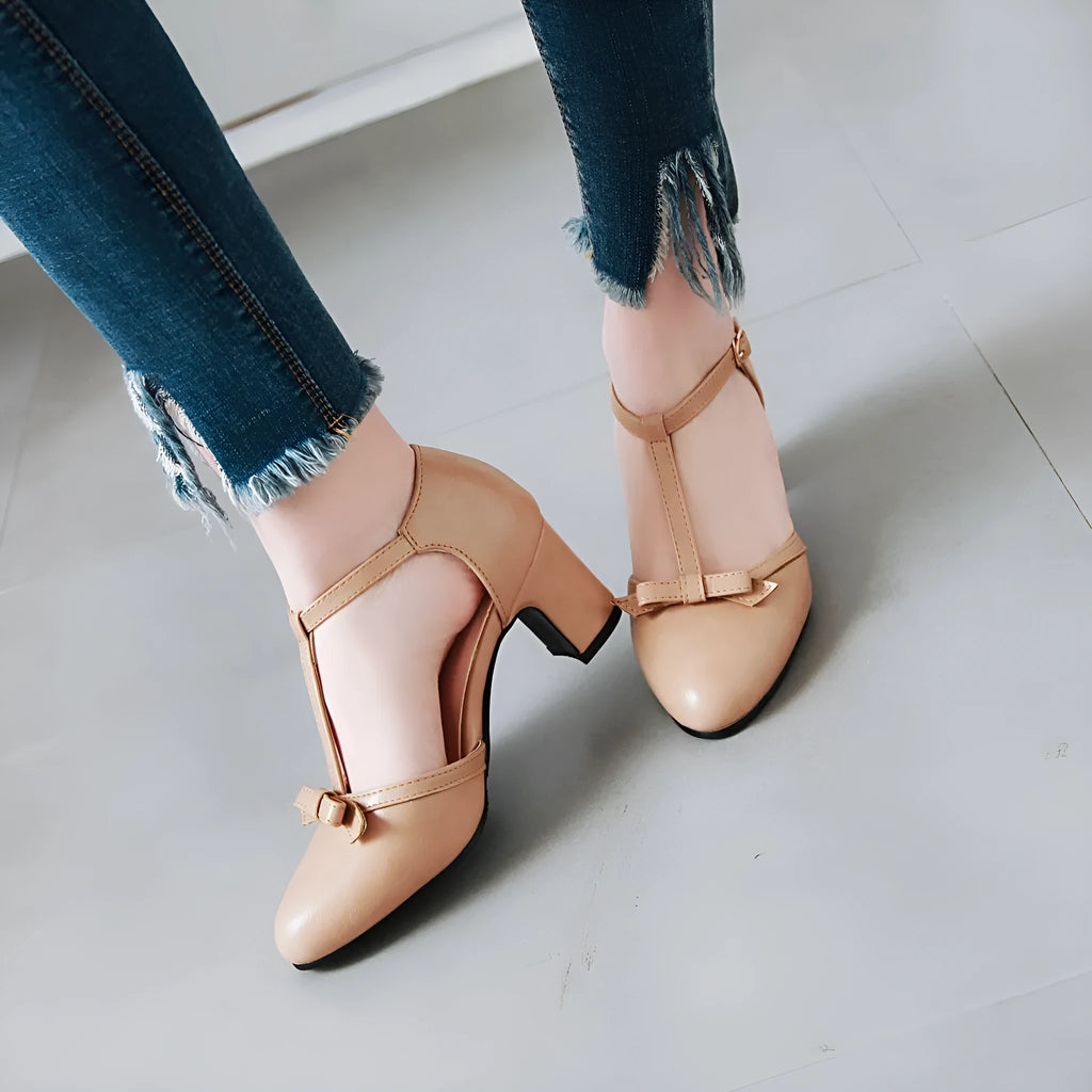 Yellow women's sandals with a chunky heel, buckle strap, and round toe.