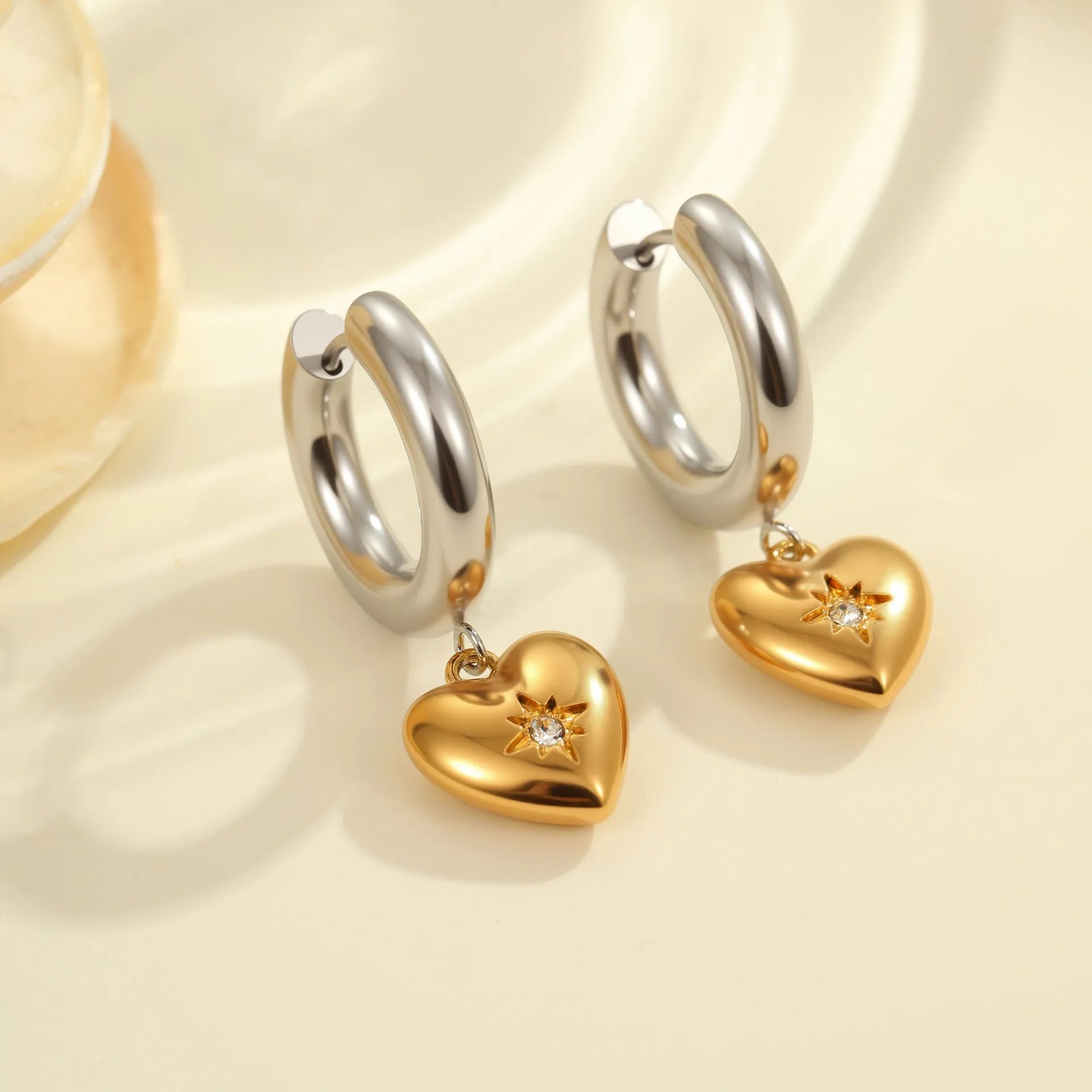 A pair of gold-coloured Christmas tree heart earrings for women, made from stainless steel with a star detail.