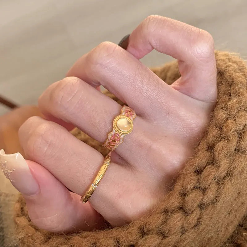 Geometric open mouth ring with pink crystal enamel detail on gold-plated copper band