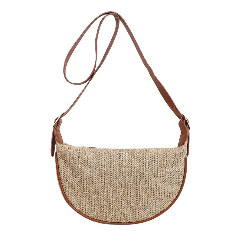 Women's knitted straw woven crossbody bag showing woven texture and internal phone and document pockets
