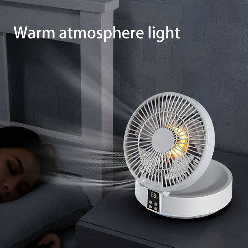 White portable folding fan with night light on a table, remote control beside it, showing its compact size.