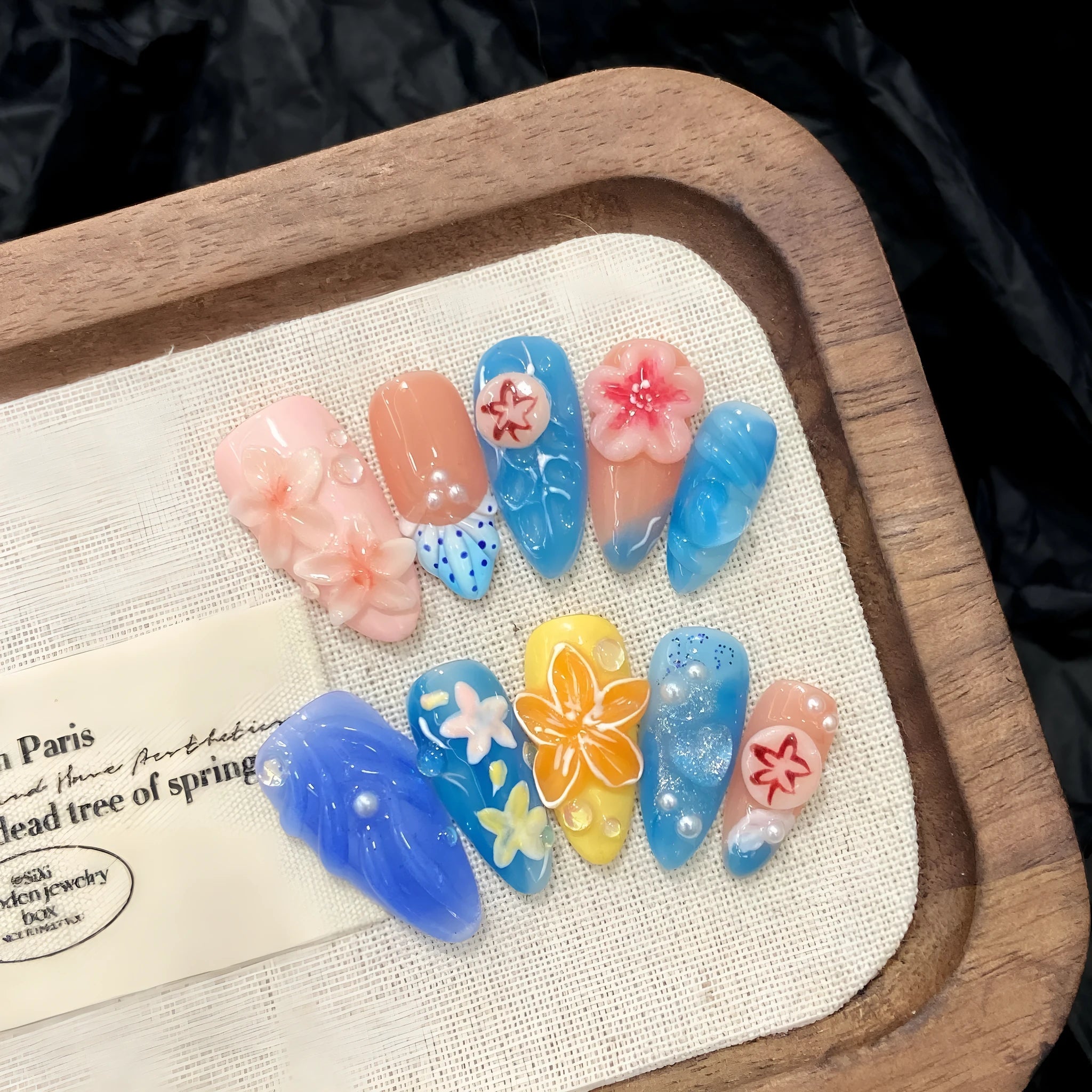 Three-dimensional carved jellyfish design on plastic wearable armour set in almond nail colour.