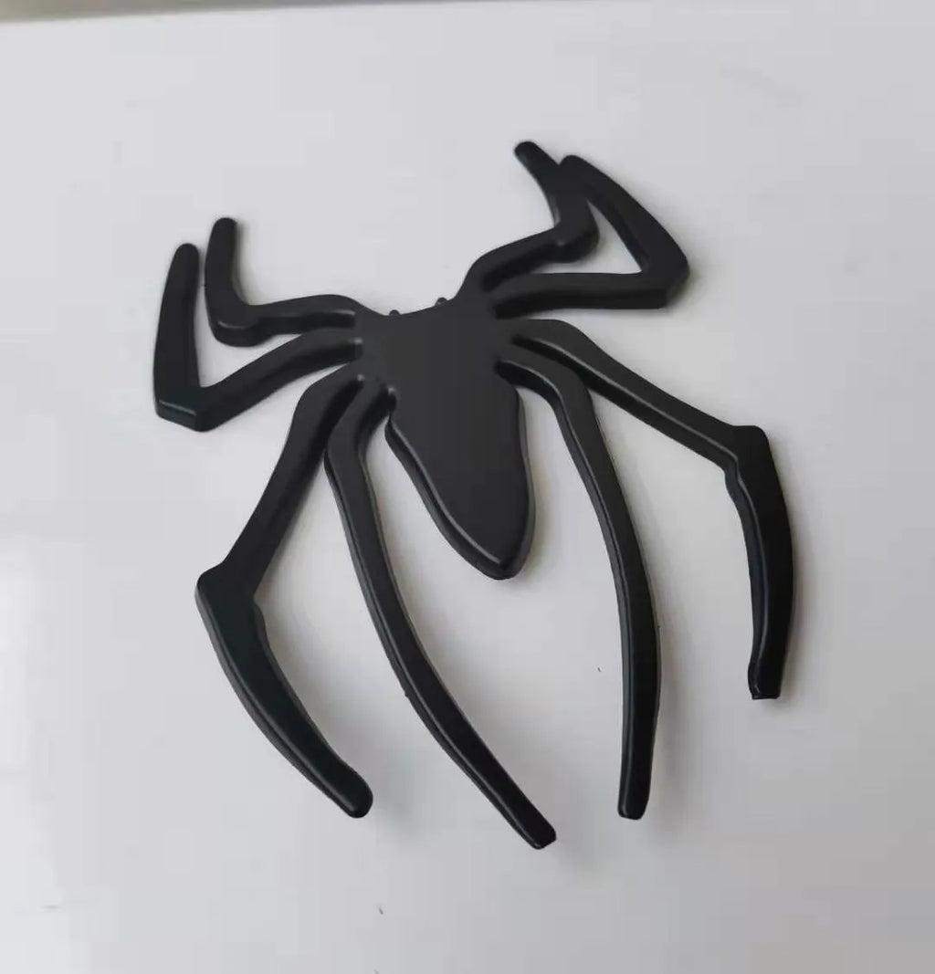 Zinc alloy 3D spider bumper sticker in metallic colours on a car bumper.