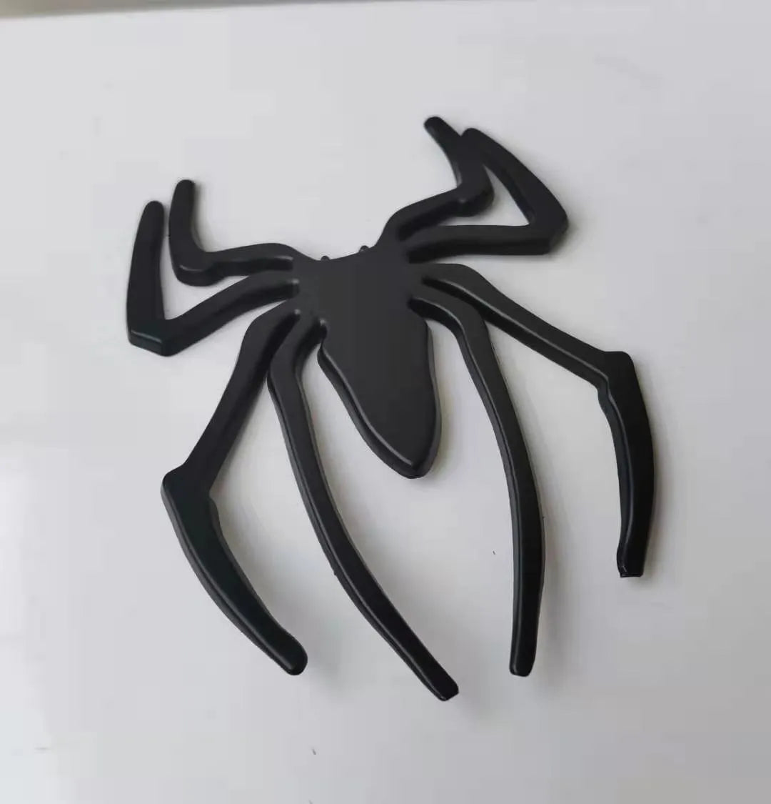 Zinc alloy 3D spider bumper sticker in metallic colours on a car bumper.