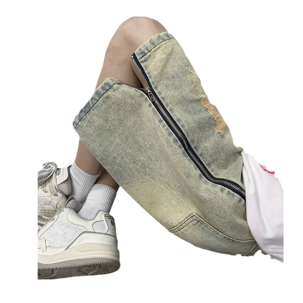 Men's loose five-point denim shorts in blue with ripped yellow-mud effect, straight leg, button fly, front view