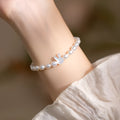White shell small rice-shaped beads pearl elastic string rabbit bracelet 16cm handmade 925 silver on white background