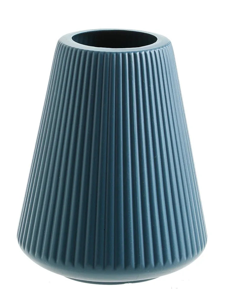 Colourful melamine plastic decorative flower vase on a desktop, 16cm wide by 20cm tall.