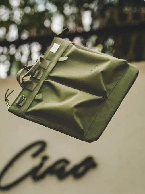 Canvas messenger bag in military green with shoulder strap and laptop compartment