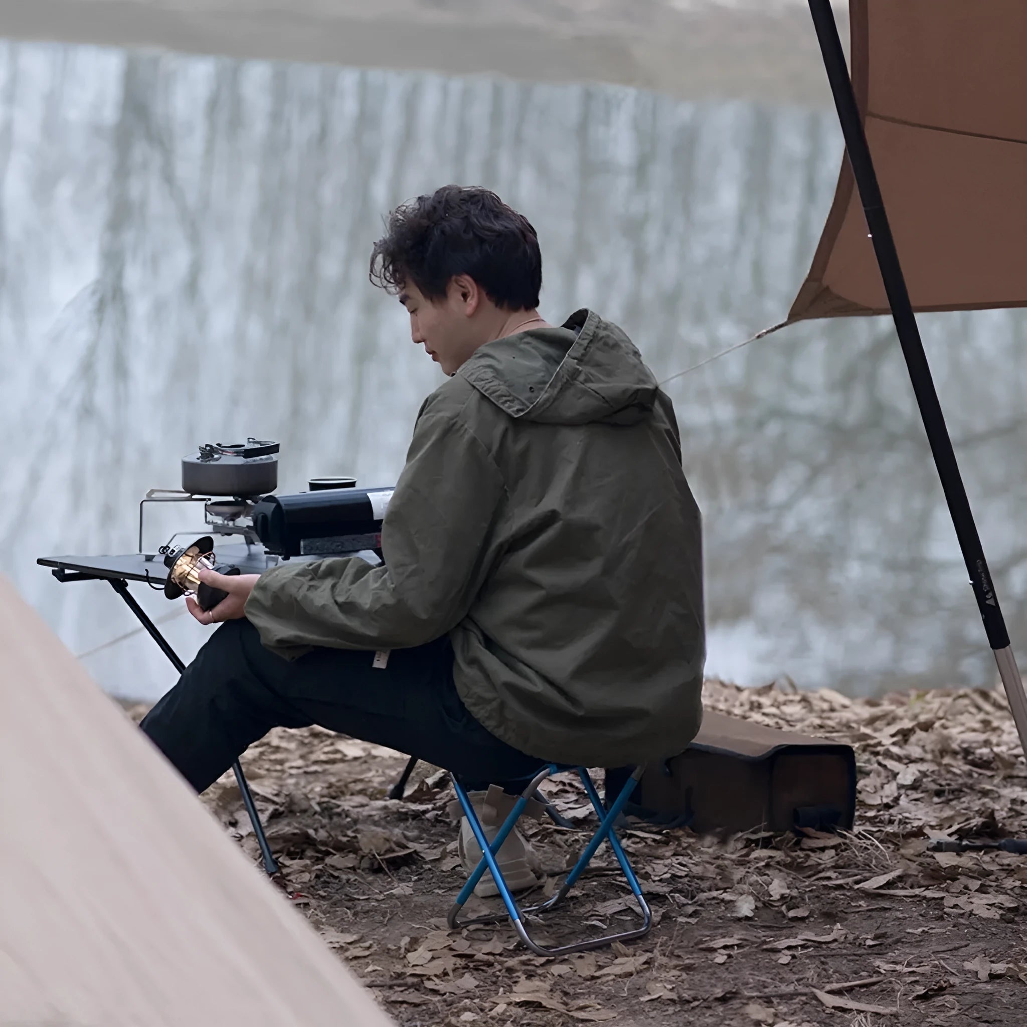 Black aluminium folding camping stool with ethnic patterning in folded and unfolded positions