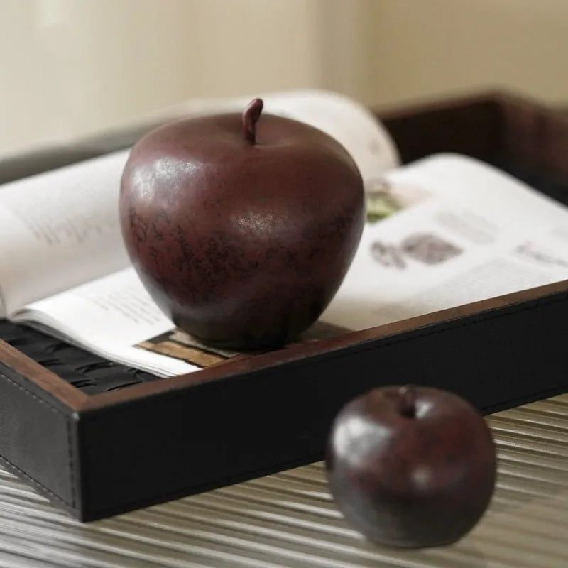 Retro Chinese style ceramic simulation apple ornament for desktop decoration on a wooden surface.