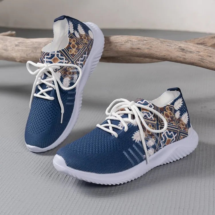 Women's woven flat shoes in green with printed totem detail, mesh upper, rubber sole, and front lace-up closure
