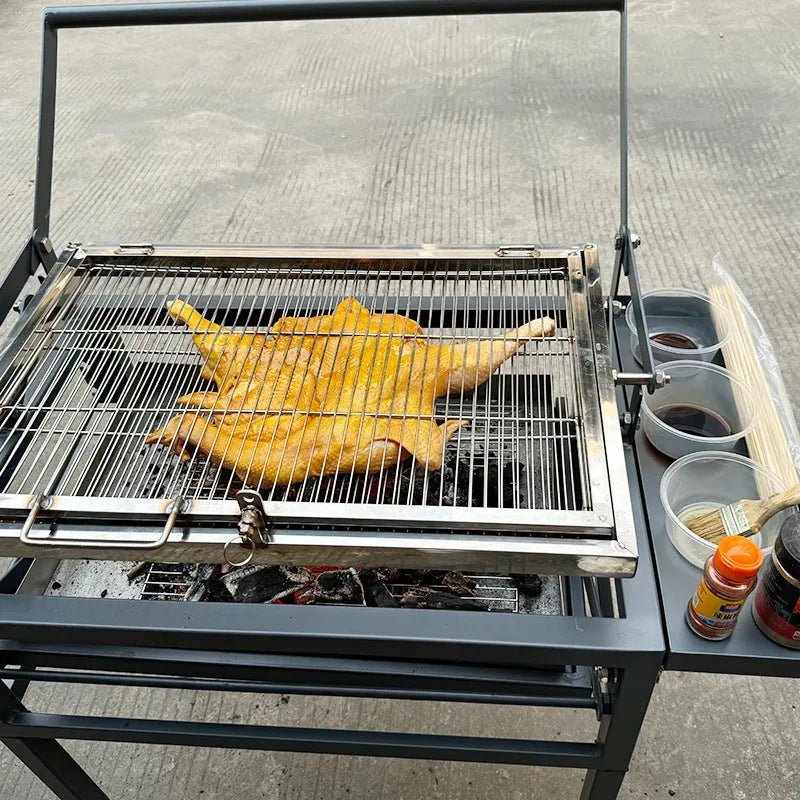 Large foldable Flip BBQ Stove charcoal barbecue grill set up in a garden.
