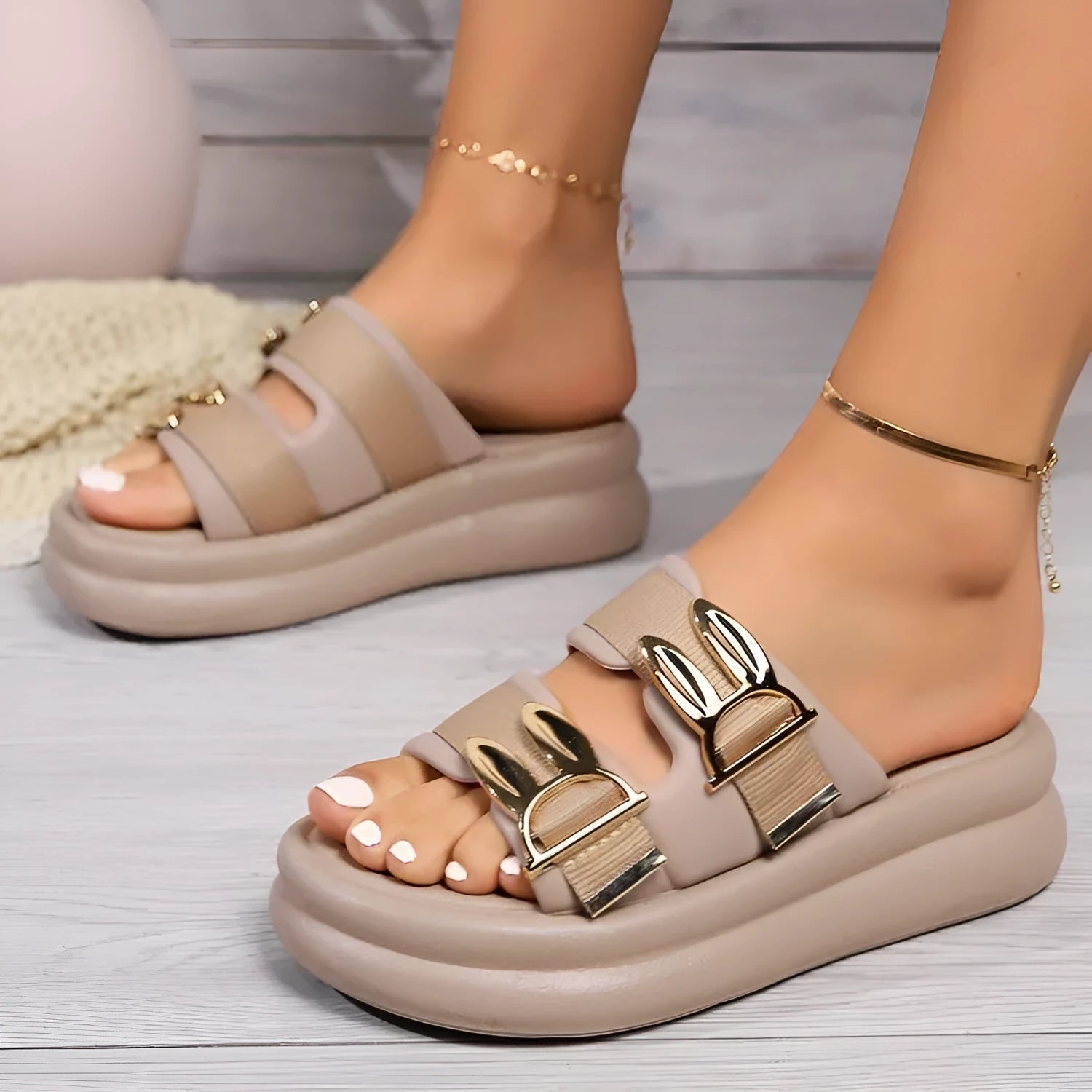 Women's apricot suede slippers with a thick rubber sole on a white background.