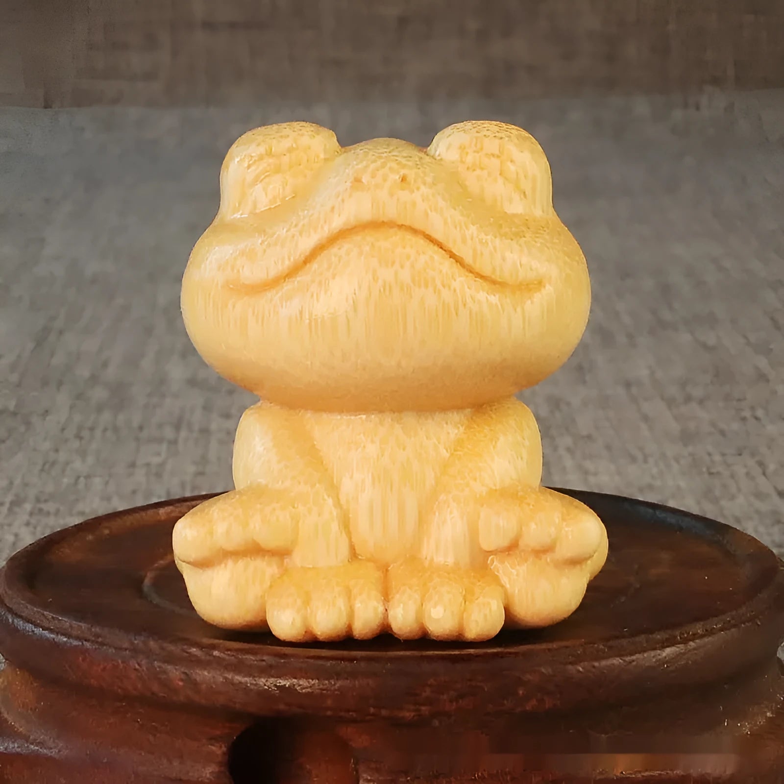 Solid bamboo smiling frog cartoon ornament measuring 5cm tall.