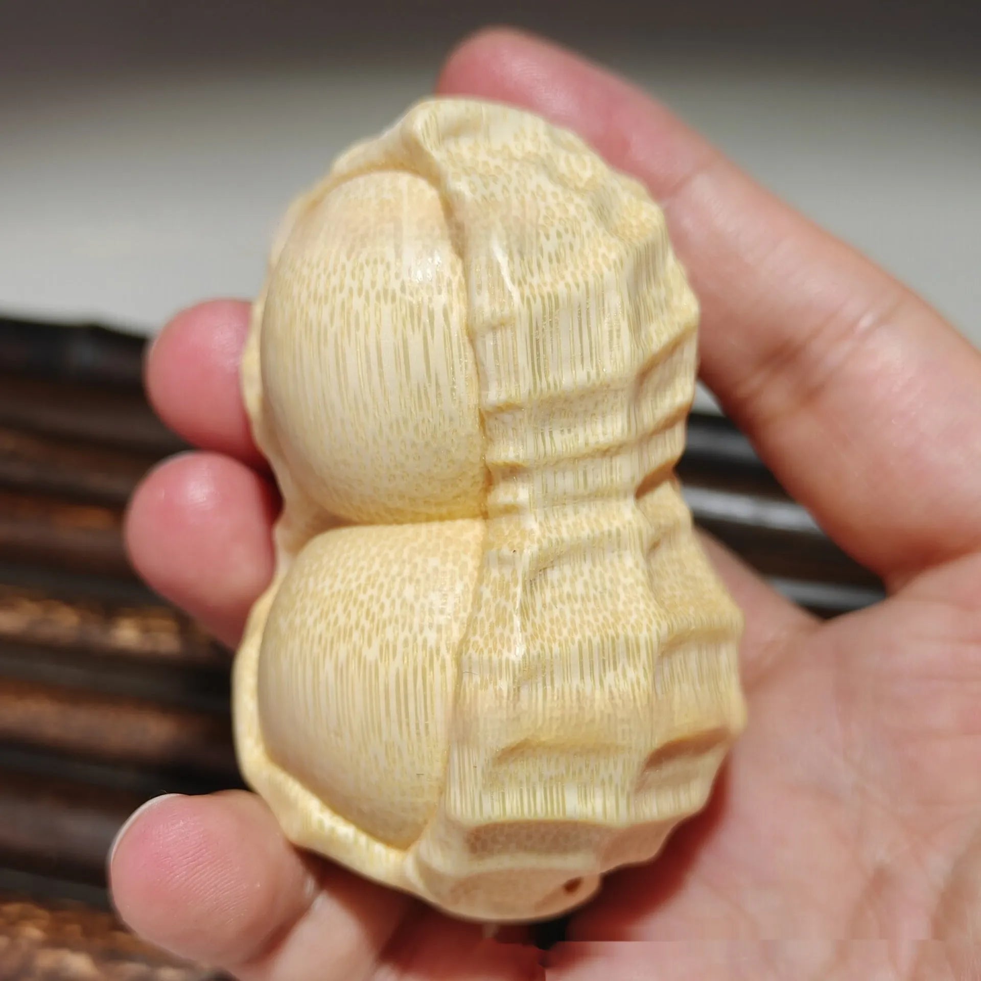Solid bamboo carved peanut ornament with modern simplicity style and symbolic message.