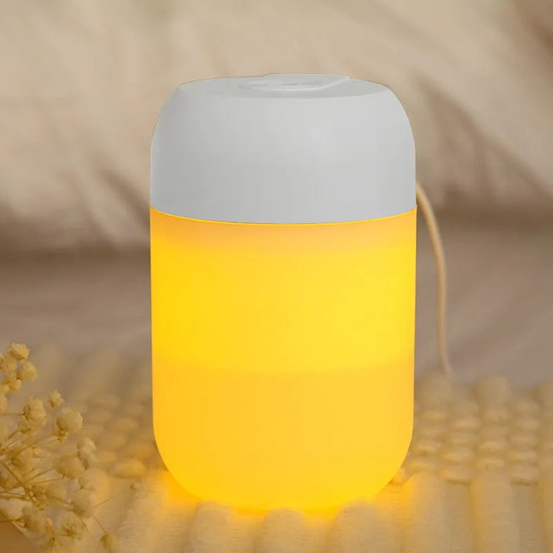 Small white cylindrical USB-powered humidifier with aromatherapy function on a desk