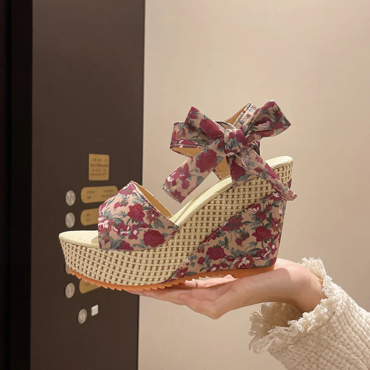 Women's wedge peep toe sandals with ankle-strap buckle, cloth upper, and rubber sole in a floral pattern.