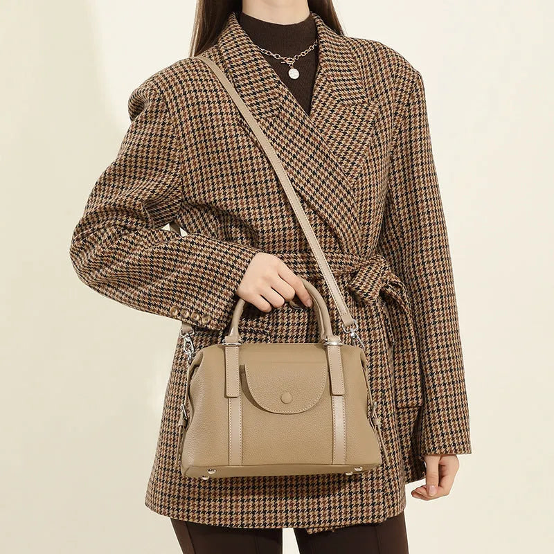 Genuine leather ladies handbag in black with contrast stitching and lock hardware
