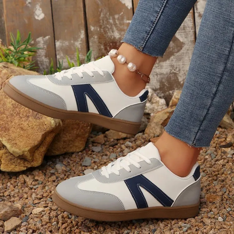 Women's blue flat German training hiking shoes with low top, front lace-up, and rubber sole