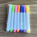Acrylic DIY note board LED night light with pens on desk, showing written message and soft glow