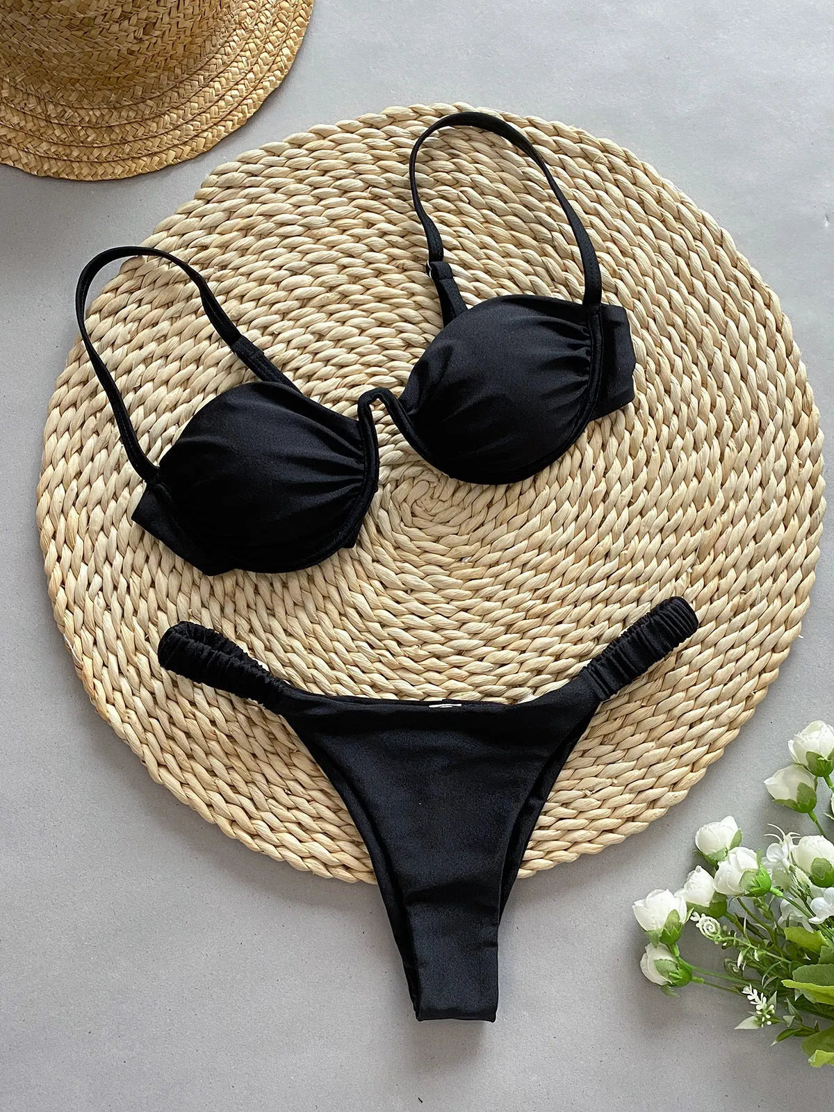 Women's black underwire bikini swimsuit set with briefs style on a mannequin.