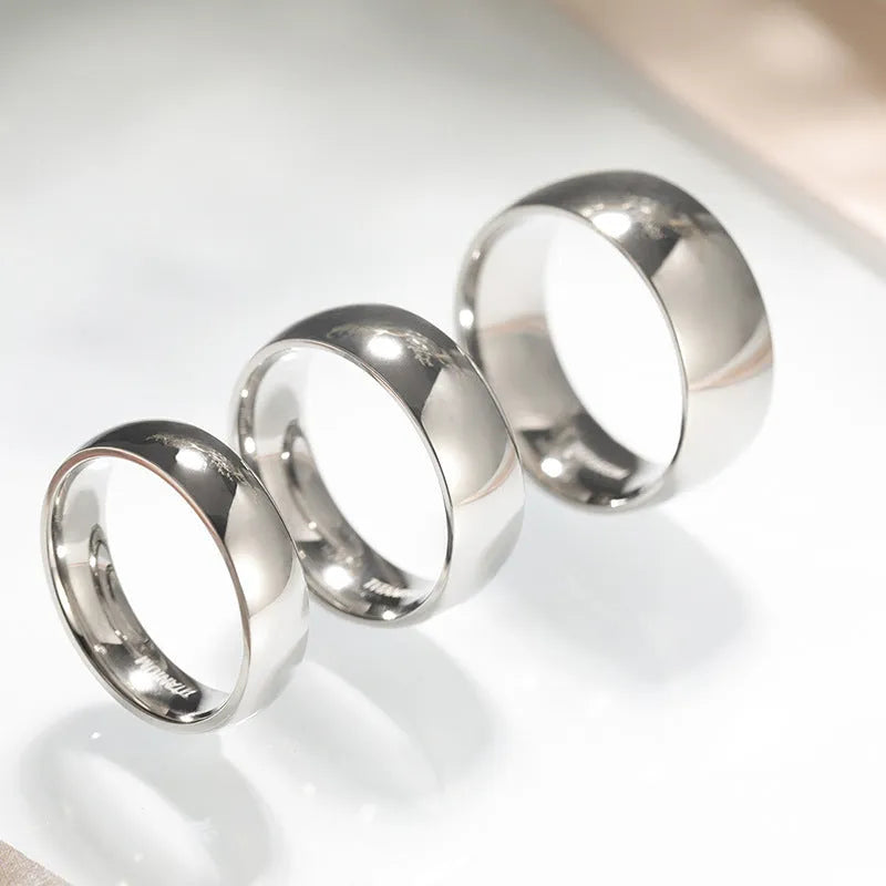 Silver pure titanium ring showing metallic finish and band width options on size guide