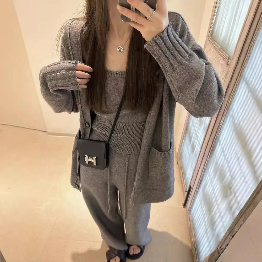 Women's light brown wool-blend knit cardigan vest and loose trousers three-piece set laid flat