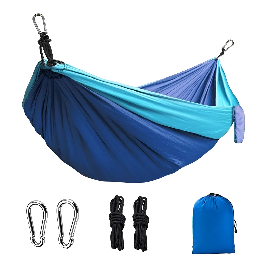 Blue parachute cloth nylon camping hammock shown hung between trees.