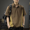 Man wearing a brown short-sleeved shirt with a half-zipped stand collar, showing the loose fit.